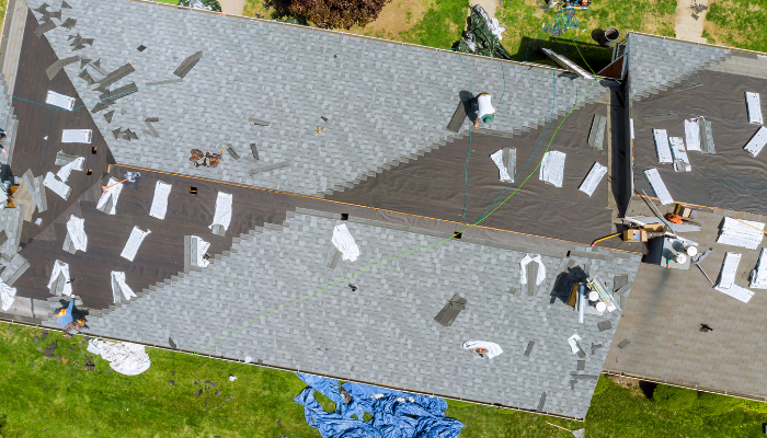 overhead shot of a roof with stacks of materials in various places on the roof